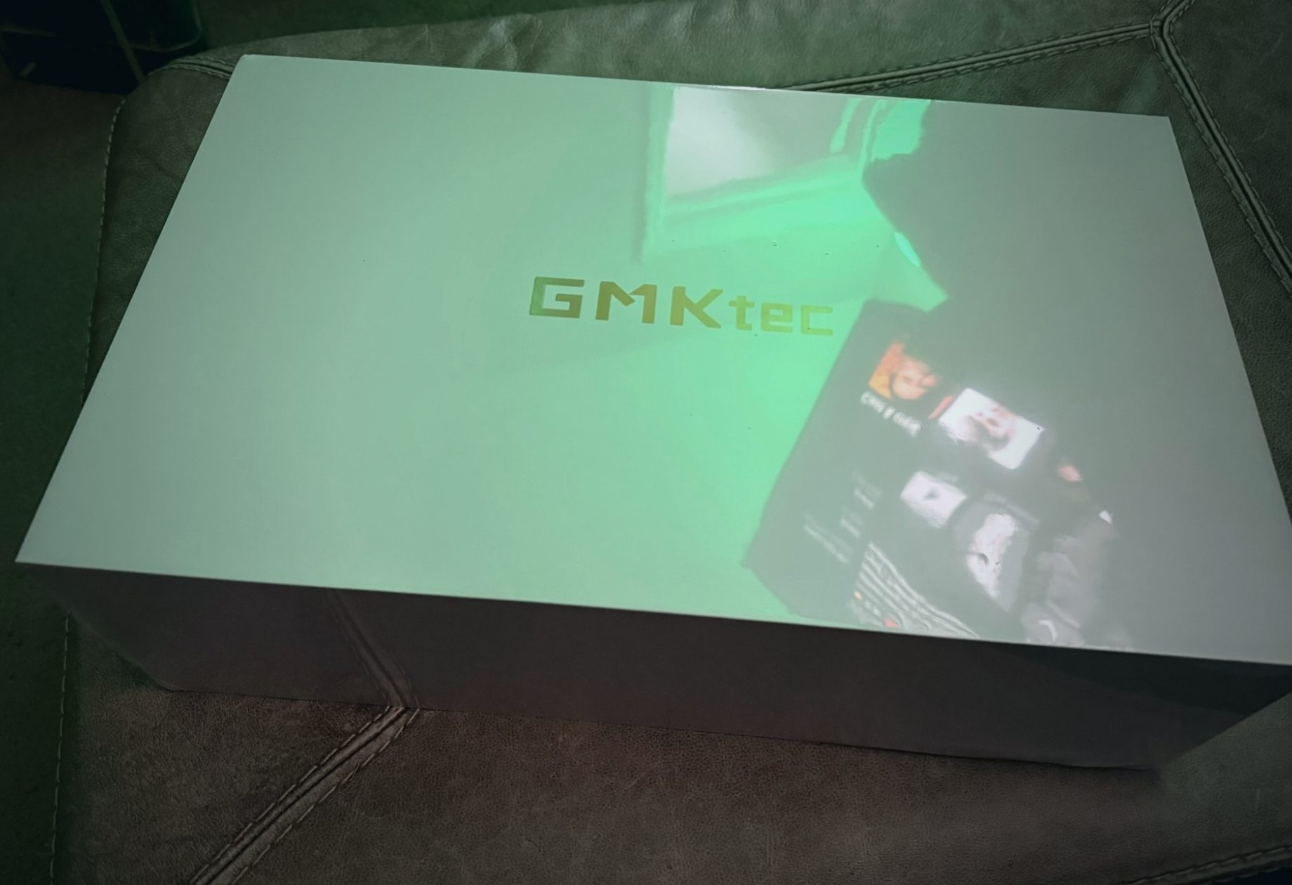 Sealed GMKtec box under green light